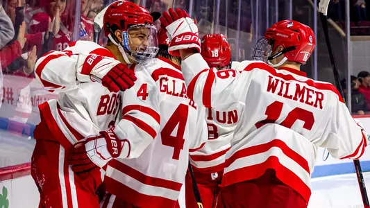 The men's ice hockey team celebrates a goal
