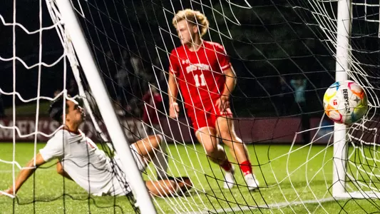 Andrew Rent scores an empty net goal as a BC defender tries to block the shot by sliding.