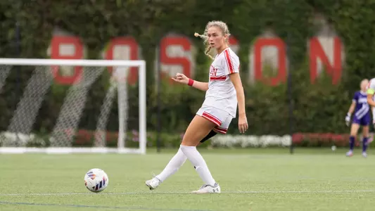 Photo of women's soccer sophomore Mackenzie Stickelman kicking a ball at Nickerson Field.