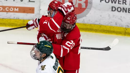 Quinn and Lane Hutson celebrate a goal at UVM