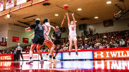 Photo of Audrey Ericksen shooting a jumper against Harvard.