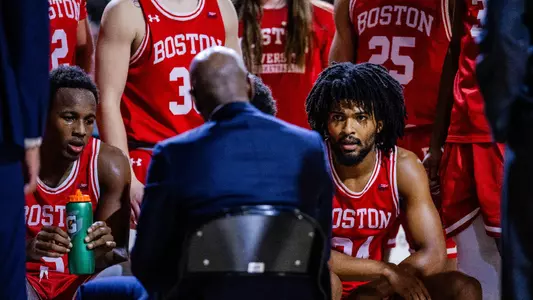 Head coach Joe Jones talks to the team sitting down in a huddle before the official tip-off at Davidson.