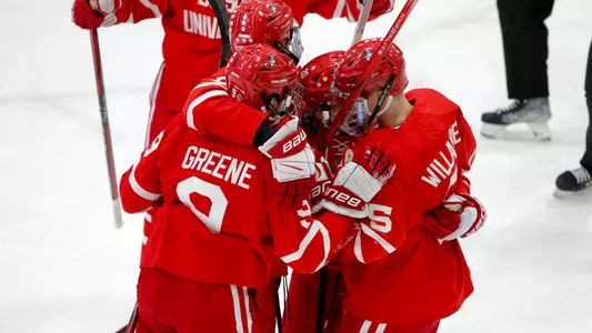 BU men's ice hockey players celebrating a goal at Vermont