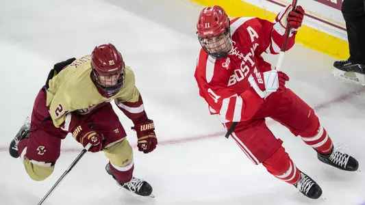 Luke Tuch skating next to a BC player
