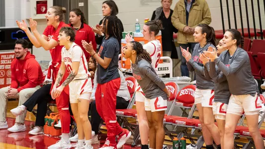 Women's basketball bench cheering during a game