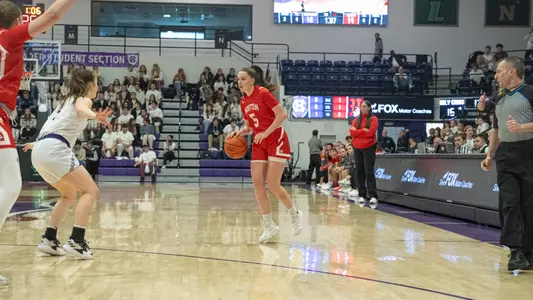 Photo of women's basketball freshman Aoibhe Gormley dribbling the basketball at Holy Cross.