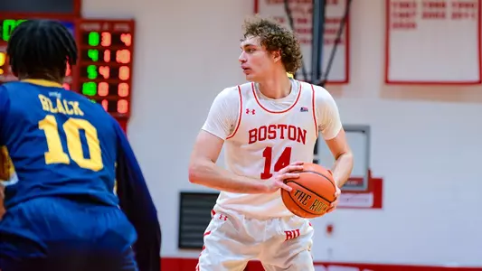 Nico Nobili holds the basketball looking to pass.