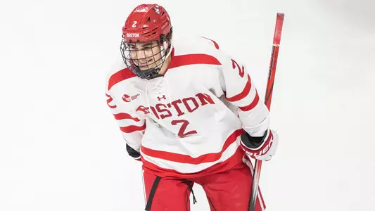 Gavin McCarthy smiling as he skates to the bench after scoring a goal