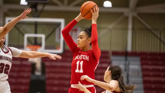 Photo of women's basketball senior Caitlin Weimar holding the ball over her head with two Lafayette defenders closing in.