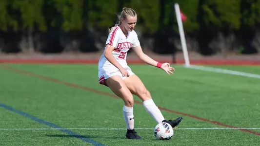 Photo of women's soccer senior Allison Hanlon kicking the ball at Nickerson Field.