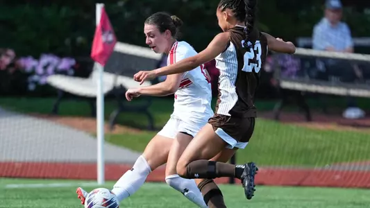 Photo of women's soccer junior Giulianna Gianino dribbling past a Lehigh defender.