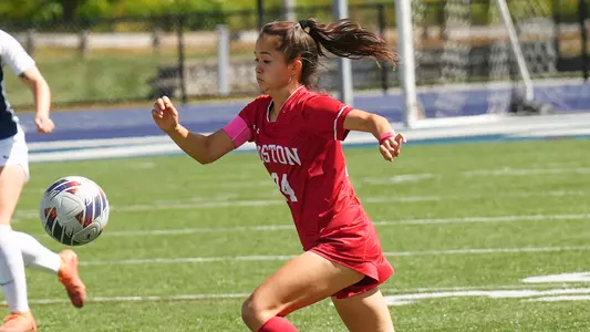 Photo of women's soccer graduate student Lily Matthews dribbling the ball in a road match.