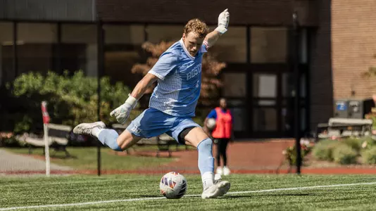 Andrew Wike is in the middle of his kicking motion as he gets set to boot the soccer ball a far distance