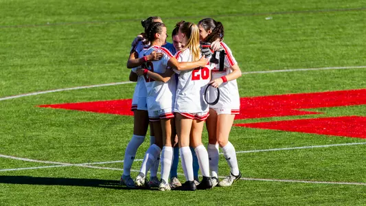 Photo of the Women's Soccer team celebrating the win over Bucknell at Nickerson Field.