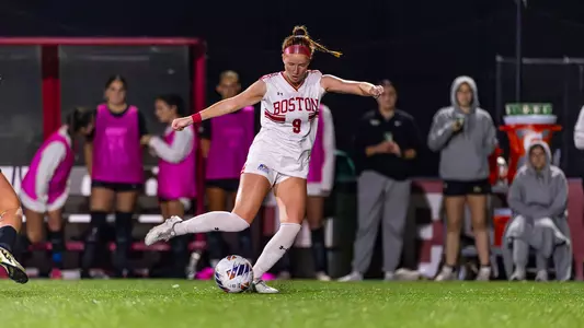 Photo of women's soccer junior Margy Porta kicking a soccer ball at Nickerson Field.
