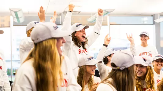 Photo of the BU women's soccer team celebrating during the 2024 NCAA Selection Show.