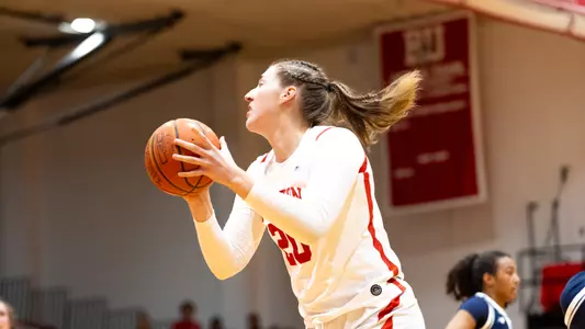Photo of women's basketball junior Anete Adler collecting a rebound at Case Gym.