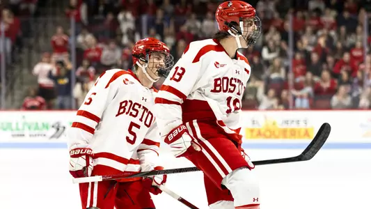 Shane Lachance celebrates a goal with Tom Willander smiling behind him