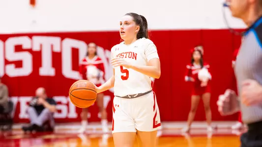 Photo of women's basketball sophomore Aoibhe Gormley dribbling the ball up the court at Case Gym.