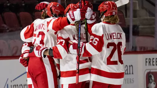 Women's ice hockey players celebrating a goal at Agganis Arena