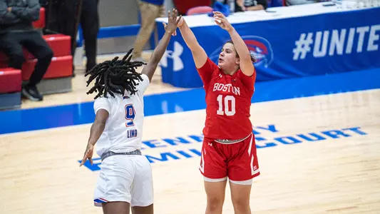 Photo of women's basketball senior Alex Giannaros shooting a basket at UMass Lowell.