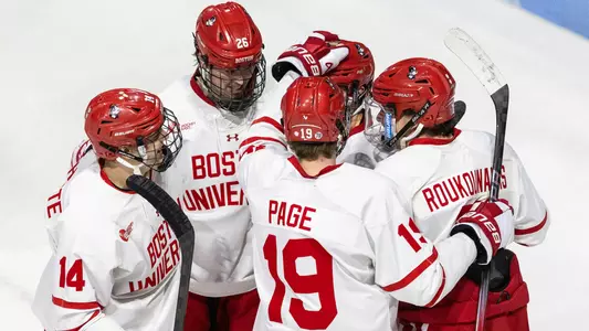 Men's ice hockey players celebrate a goal