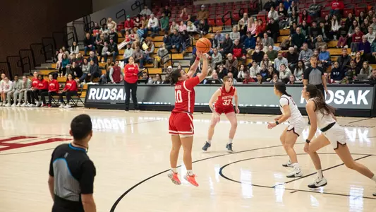 Photo of women's basketball senior Alex Giannaros shooting a jumper at Harvard.