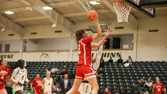 Photo of women's basketball freshman Allison Schwertner shooting a layup at Le Moyne.