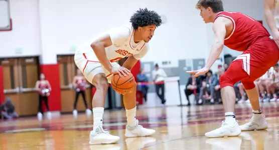 Matai Baptiste holds the ball with a Sacred Heart defender in front