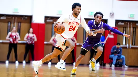 Miles Brewster dribbling past a UAlbany defender