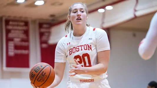 Photo of women's basketball junior Anete Adler about to pass a basketball at Case Gym.