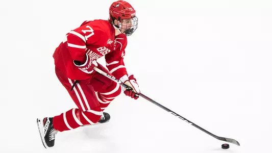 Macklin Celebrini skating with the puck