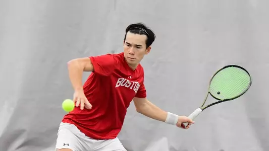 Corey Craig swings a forehand with the tennis ball approaching in the air