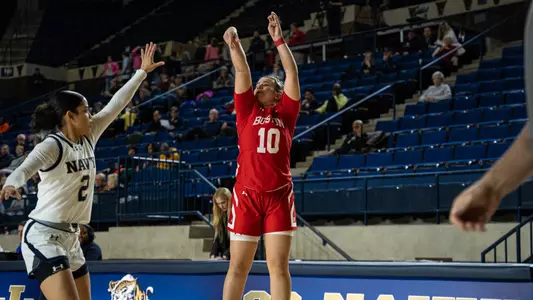 Photo of women's basketball junior Alex Giannaros shooting a three-pointer against Navy.
