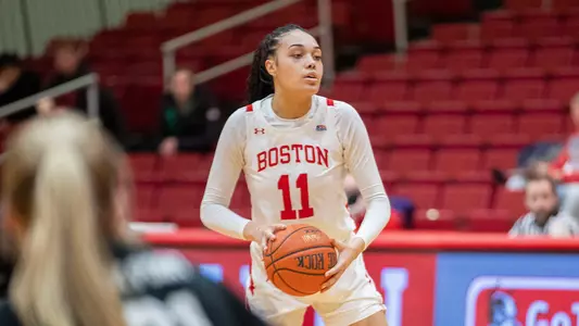 Photo of women's basketball senior Caitlin Weimar looking to pass the ball.