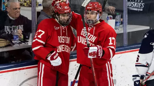 Jack Hughes and Quinn Hutson celebrate a goal at UConn
