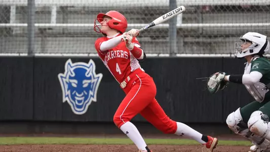 Brooke Deppiesse lofts a pitch into the air against Michigan State batting right handed.