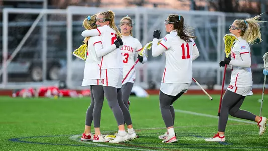 Women's lacrosse celebrates a goal