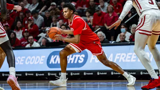 Ethan Okwuosa dribbles the ball around the perimeter at Rutgers