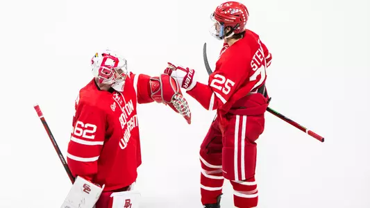 Sam Stevens and Mathieu Caron tap gloves after a BU goal