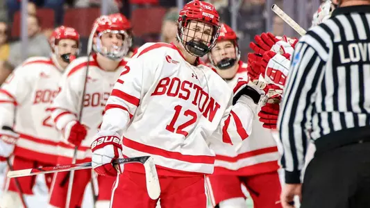 Jack Harvey celebrates as he skates by the BU bench after one of his two goals against Merrimack