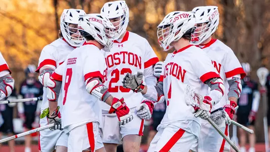 Men's lacrosse players celebrating a goal