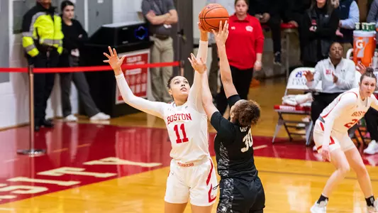 Photo of women's basketball senior Caitlin Weimar blocking an Army West Point shot.