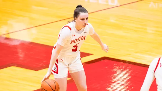 Photo of women's basketball freshman Aoibhe Gormley dribbling the ball against Army West Point.