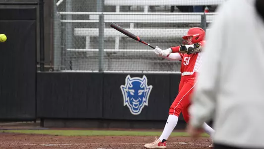 Kylie Doherty makes hard contact with a pitch batting right handed and fully extended