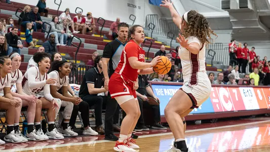 Photo of women's basketball junior Alex Giannaros surveying the court for a pass at Colgate.