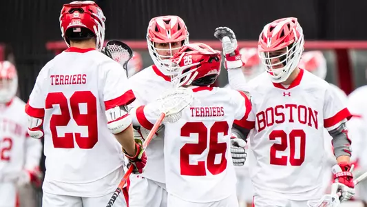 Men's lacrosse players celebrating a goal