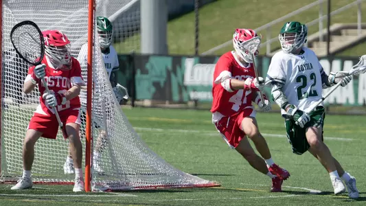 Will Barnes watches as BU defender plays against a Loyola attacker