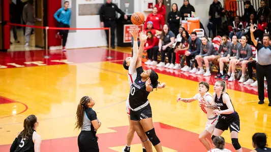 Photo of Caitlin Weimar and Holy Cross' Janelle Allen taking the opening tip at Case Gym.