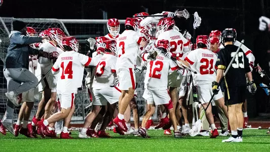 The men's lacrosse team celebrates its win over No. 1 Army West Point